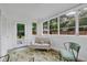 Bright sunroom with neutral furniture, decorative rug, and large windows overlooking the backyard at 1210 S Palmetto Ave, Sanford, FL 32771