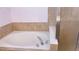 Close-up of the bathroom bathtub showcasing tile surround, chrome fixtures, and glass shower enclosure at 12630 Old Plantation Ln, Orlando, FL 32824