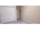 Bright bedroom boasts a spacious closet with white doors and modern light gray flooring at 12630 Old Plantation Ln, Orlando, FL 32824