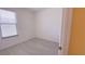 Bright bedroom with a large window offering natural light and stylish gray flooring at 12630 Old Plantation Ln, Orlando, FL 32824