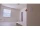 Bedroom featuring minimalist design with a bright window and laminate flooring at 12630 Old Plantation Ln, Orlando, FL 32824