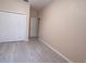 Bright bedroom features a spacious closet with white doors and modern light gray flooring at 12630 Old Plantation Ln, Orlando, FL 32824
