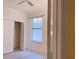 Bright bedroom featuring laminate flooring, window with blinds, and built-in closet with opened doors at 12630 Old Plantation Ln, Orlando, FL 32824