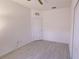 Empty bedroom featuring light laminate floors and a door and a closet door at 12630 Old Plantation Ln, Orlando, FL 32824
