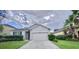Charming single-story home featuring manicured landscaping and a two-car garage for convenience at 12630 Old Plantation Ln, Orlando, FL 32824