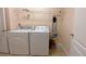 Functional laundry room equipped with a washer, dryer, and convenient overhead storage shelving at 12630 Old Plantation Ln, Orlando, FL 32824