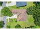 Aerial view of home with mature trees, driveway, walkway and manicured lawns, and nearby neighborhood at 13943 Caywood Pond Dr, Windermere, FL 34786