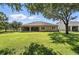 Lush backyard features a large grassy area with mature trees and a screened lanai at 13943 Caywood Pond Dr, Windermere, FL 34786