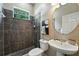 Modern bathroom featuring updated tile shower, sleek fixtures, and decorative accents over the commode at 13943 Caywood Pond Dr, Windermere, FL 34786