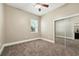 Inviting bedroom with plush carpeting and closet with mirrored doors for ample storage at 13943 Caywood Pond Dr, Windermere, FL 34786