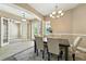 Formal dining room with elegant chandelier and natural light from large windows at 13943 Caywood Pond Dr, Windermere, FL 34786