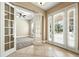 Welcoming entryway featuring neutral tones, tile flooring, and a view of a sunlit office space at 13943 Caywood Pond Dr, Windermere, FL 34786