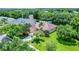 Exterior view of a well-maintained home with mature trees, a green lawn and lush landscaping at 13943 Caywood Pond Dr, Windermere, FL 34786