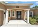 Inviting front entrance with decorative columns and a stylish glass-paneled door at 13943 Caywood Pond Dr, Windermere, FL 34786