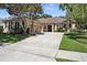 Well-maintained single-story home with a spacious driveway and a manicured lawn at 13943 Caywood Pond Dr, Windermere, FL 34786