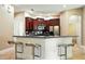 Modern kitchen with stainless steel appliances, rich wood cabinets, and a convenient breakfast bar at 13943 Caywood Pond Dr, Windermere, FL 34786