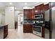 Well-equipped kitchen featuring stainless steel appliances and rich wooden cabinetry at 13943 Caywood Pond Dr, Windermere, FL 34786