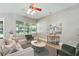 Comfortable living room with a cozy seating area, large windows, and tasteful decor at 13943 Caywood Pond Dr, Windermere, FL 34786