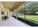 Screened patio with ceiling fan offers an inviting outdoor seating area overlooking the lush backyard at 13943 Caywood Pond Dr, Windermere, FL 34786