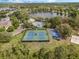 Aerial view of the community tennis and basketball courts near a lake at 13943 Caywood Pond Dr, Windermere, FL 34786