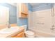 Bright bathroom with a combination shower and tub, toilet and vanity with sink at 1425 Hollyberry Pl, The Villages, FL 32162