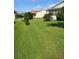 Well-manicured front lawn featuring lush grass and meticulously trimmed landscaping at 1425 Hollyberry Pl, The Villages, FL 32162