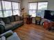 Inviting living room with hardwood floors and plenty of natural light at 1425 Hollyberry Pl, The Villages, FL 32162