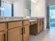Bathroom vanity with double sinks, wooden cabinets, granite countertops, and updated fixtures at 15071 Guava Bay Dr, Winter Garden, FL 34787