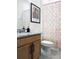 Bathroom featuring a wood vanity, decorative painting, and colorful shower curtain at 15071 Guava Bay Dr, Winter Garden, FL 34787