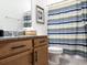 Bathroom featuring a wood vanity, stylish shower curtain, and granite countertops at 15071 Guava Bay Dr, Winter Garden, FL 34787