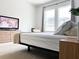 Bright bedroom featuring a large window, neutral tones, and sleek furniture at 15071 Guava Bay Dr, Winter Garden, FL 34787