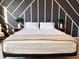 Modern bedroom features a statement wall with a geometric design at 15071 Guava Bay Dr, Winter Garden, FL 34787