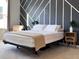 Modern bedroom features statement wall and coordinated furnishings at 15071 Guava Bay Dr, Winter Garden, FL 34787