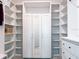 Custom closet with white shelves, cabinets, and a mirrored wardrobe for optimal storage and style at 15071 Guava Bay Dr, Winter Garden, FL 34787