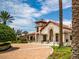 Elegant clubhouse with well-manicured landscaping and a circular driveway, welcoming residents and guests at 15071 Guava Bay Dr, Winter Garden, FL 34787