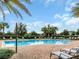 Lounge poolside at the community pool surrounded by lush landscaping and lounge chairs at 15071 Guava Bay Dr, Winter Garden, FL 34787