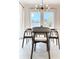 Bright dining room features tile flooring, large windows and modern light fixture at 15071 Guava Bay Dr, Winter Garden, FL 34787