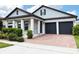 Attractive one-story home with a brick driveway and a two-car garage, offering curb appeal and functionality at 15071 Guava Bay Dr, Winter Garden, FL 34787