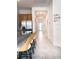 The hallway features stylish counter seating at the kitchen counter and neutral-colored tile at 15071 Guava Bay Dr, Winter Garden, FL 34787