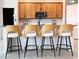 Kitchen island featuring barstool seating, granite countertops, and stainless steel appliances, and subway tile backsplash at 15071 Guava Bay Dr, Winter Garden, FL 34787