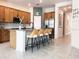 Open kitchen featuring a large island with seating, granite countertops, and modern stainless steel refrigerator at 15071 Guava Bay Dr, Winter Garden, FL 34787