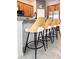 Kitchen island featuring stylish seating, granite countertops, subway tile backsplash, and ample cabinet space at 15071 Guava Bay Dr, Winter Garden, FL 34787