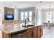 Modern kitchen with granite counters, stainless steel appliances, and a seamless flow to the living and dining areas at 15071 Guava Bay Dr, Winter Garden, FL 34787
