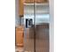 Stainless steel refrigerator featuring ice and water dispenser, plus wood cabinets and a subway tile backsplash at 15071 Guava Bay Dr, Winter Garden, FL 34787