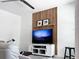 Cozy living room with decorative slat wall, floating shelf, and flatscreen TV on entertainment center at 15071 Guava Bay Dr, Winter Garden, FL 34787