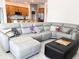 Spacious living room with a comfortable sectional couch and adjacent kitchen area at 15071 Guava Bay Dr, Winter Garden, FL 34787
