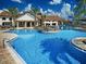 Stunning community pool with a splash zone, umbrellas, and ample seating, perfect for relaxation and recreation at 15071 Guava Bay Dr, Winter Garden, FL 34787