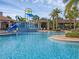 Resort-style pool area featuring a splash zone, slide, and plenty of seating for Gathering fun in the sun at 15071 Guava Bay Dr, Winter Garden, FL 34787