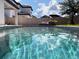 Stunning swimming pool reflecting the sky and surrounding trees, creating a tranquil and picturesque scene at 15071 Guava Bay Dr, Winter Garden, FL 34787