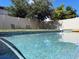 Serene swimming pool view with chairs and lush landscaping along the fence, perfect for peaceful afternoons at 15071 Guava Bay Dr, Winter Garden, FL 34787